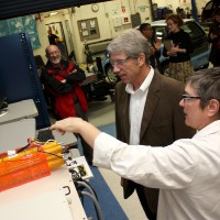 Instructor Kim Kittinger discusses the battery research lab and the tools of the trade with Schrader.