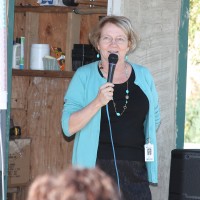 Birgitte Ryslinge chats with a crowd during the Rock Creek Learning Garden celebration last October.