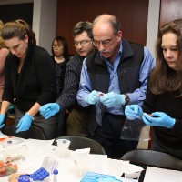 Left to right, Emily Stump (Commissioning Agents), Heather Newman (AeroTek), Stuart Roberts (Welch Allyn), Andy Goldstein (HydraDx) and Cheryl Bondurant (HemCon) begin the DNA Test. Nancy Lime (Oligos Etc.) is in the background.