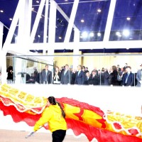 Barack Obama in background as Chow's group performs.