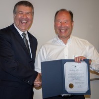 New PCC President Jeremy Brown (left) swore in Ken Madden onto the board on July 18.