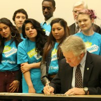 Dozens of students in the PCC Foundation’s Future Connect Program gathered around the Governor to watch him sign the bills in front of gathered media and legislators.