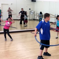 Alder students take a spin with hula hoops in the PCC dance studio.