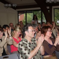 The crowd applauds the board's vote.