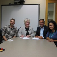 Signing the Memorandum of Understand are (left) Johanna Flores, Dreamer and PCC student; Kyle Pratuch, college resource coordinator for the Foundation; Sandra Fowler-Hill, president of the Rock Creek Campus; Mark Langseth, president & CEO of I Have A Dream Foundation; Brenda Ivelisse, associate dean of students at Rock Creek, and Traci Rossi, vice president for programs at the Foundation.