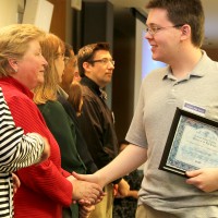 Vice President of Academic Services Chris Chairsell congratulates Century High School student Kamran Hetke, who earned credit in computer technology through PCC.