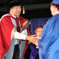 PCC President Jeremy Brown hands out diplomas on stage at the Memorial Coliseum during the college’s commencement in June.