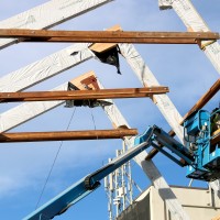 Workers put in place giant trusses on Oct. 8 to help support the new atrium entrance to the College Center.