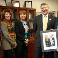 PCC President Jeremy Brown presents U.S. Sen. Jeff Merkley's Chief of Staff, Mike Zamore (far right), and his Education Policy Legislative Assistant, Susan Lexer (far left), a framed feature article honoring Sen. Merkley. Also on hand were, left to right, Traci Fordham (chief of staff) and Sylvia Kelley (vice president).