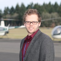 Seth Hansen at Hillsboro Airport with Robinson helicopters in the background.