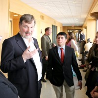 State Rep. Brad Witt talks with the PCC legislative group led by Rock Creek Campus President Sandra Fowler-Hill (left) in the hall of the state's Capitol Building.