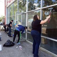 ASPCC student leaders chip in to help remove graffiti on building across the street.