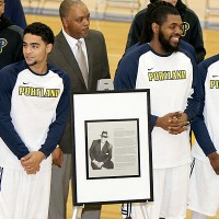 players standing with the commemorative plaque