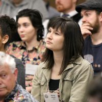 Serena Dressel, a volunteer coordinator with Portland State University's Student Sustainability Center, listens to PCC's Briar Schoon's overview of the college's green programs.