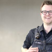 Austin Herr standing against a blank background in his Public Safety uniform