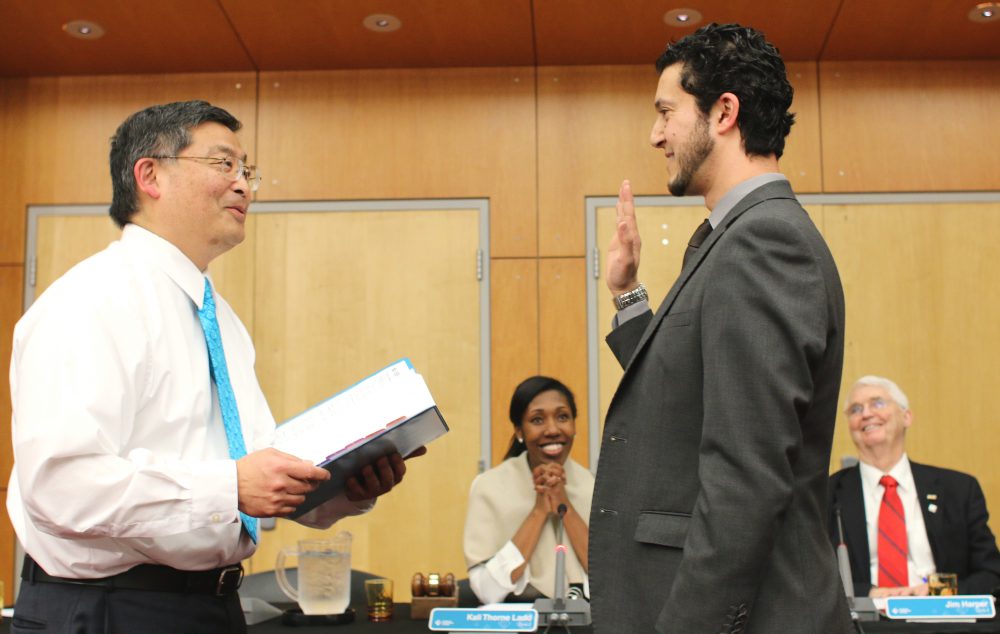 PCC President Mark Mitsui swears in new board member Mohamed Alyajouri.