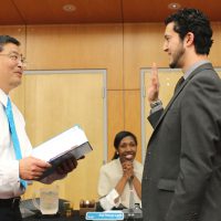 PCC President Mark Mitsui swears in new board member Mohamed Alyajouri.