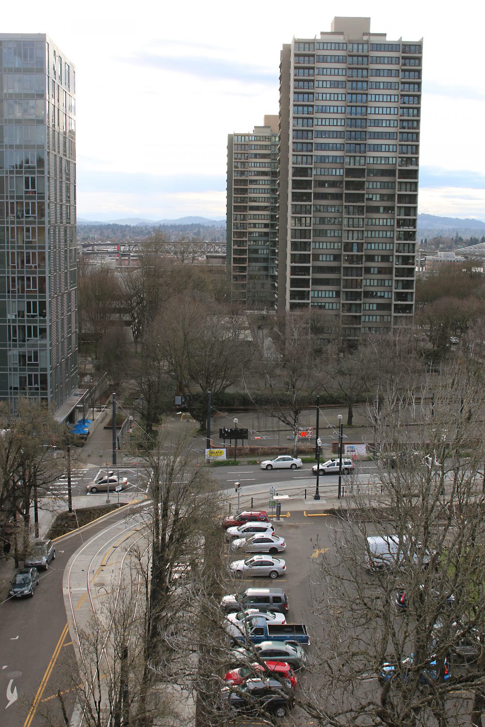Below, the surface parking lot that will be converted to the new building.