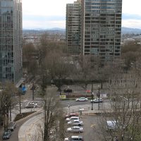 Below, the surface parking lot that will be converted to the new building.