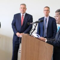 PCC President Mark Mitsui talks to reporters about the impact of the historic collaboration as PSU President Wim Wievel, OHSU President Joseph Robertson and City mayor Ted Wheeler look on.