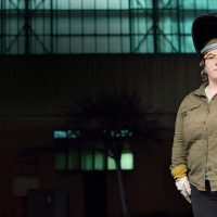 Ash standing outside wearing her welding gear