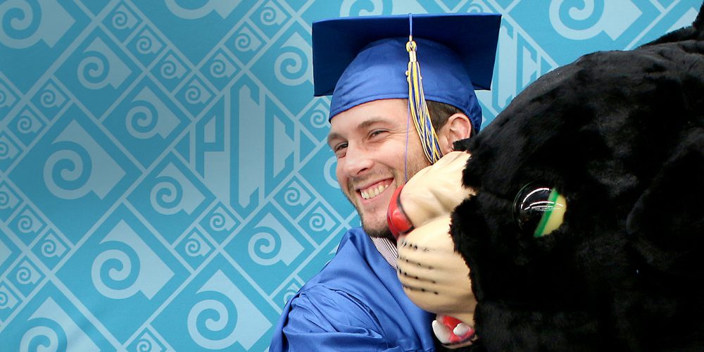 Student hugging Poppie at graduation