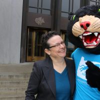 Poppiethe Panther and Lisa Avery in front of the Oregon Capitol