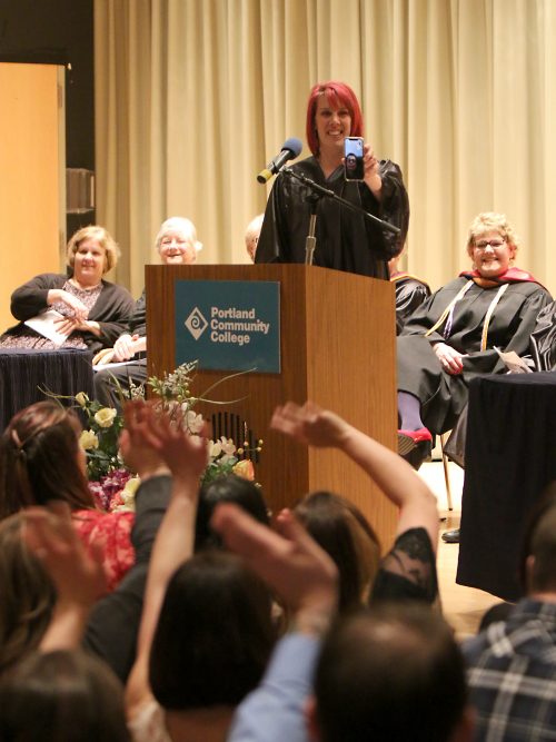 Deb Roberts helps a fellow instructor Skype into the nursing pinning ceremony.