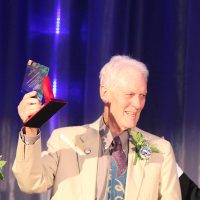 Left to right, Howard Butzer and Robert Wimmer receive the Patron Award from Mark Mitsui, PCC president.