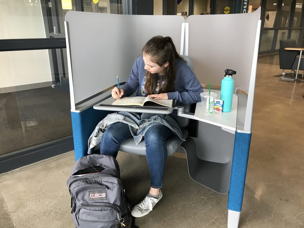 PCC Sylvania student Anna Mueller enjoys working in the study pods in CC's new Upper Mall common area. The pods feature an ergonomically designed chair, adjustable desk, and opaque screen that reduce distraction and help her stay on task.