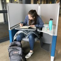 PCC Sylvania student Anna Mueller enjoys working in the study pods in CC's new Upper Mall common area. The pods feature an ergonomically designed chair, adjustable desk, and opaque screen that reduce distraction and help her stay on task.