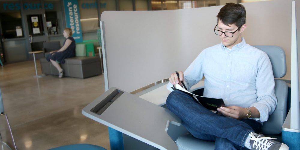 Student studying outside a resource center