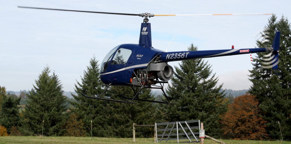 A Robinson-22 helicopter comes in for a landing at Rock Creek. This is the type of aircraft that students train on in the new flight simulation room.