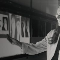 Black and white photo of student looking at x-rays