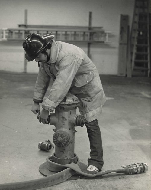 Fire Science student with hydrant.