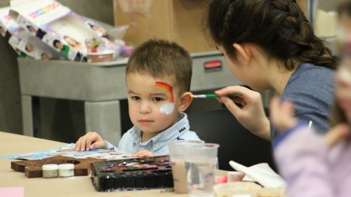 kid getting face paint.