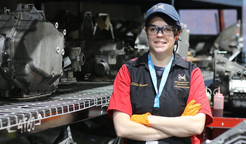 Lilly Boone poses among the shop's engines.