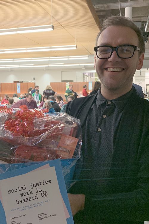 Winning employee holds basket won