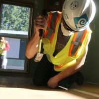 Student working on flooring.