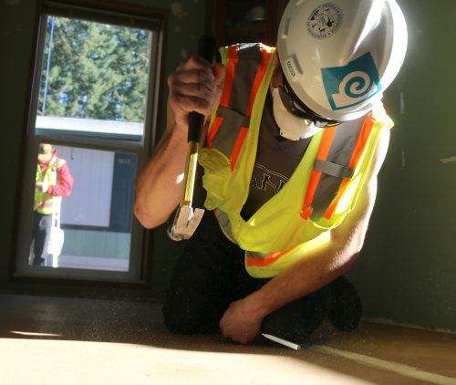 Student working on flooring.