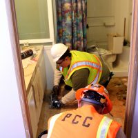 Students fixing mobile home.