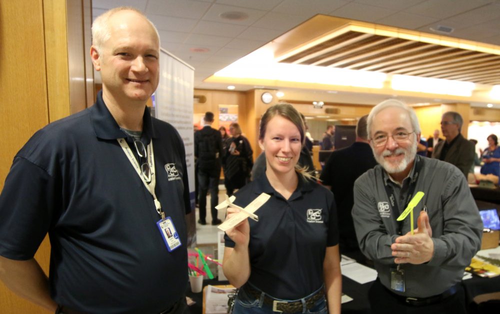 Kendra Uhl with Larry Altree and Marshall Pryor holding planes.