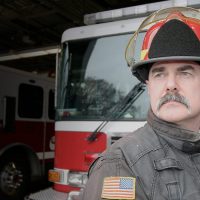 Steven Black poses in front of engine bay.