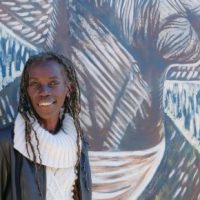 Joaan hardesty in front of some art.