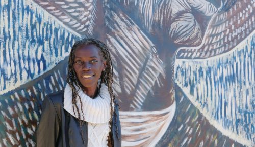 Joaan hardesty in front of some art.