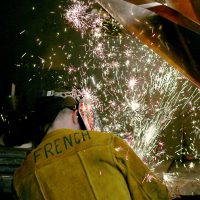 Maritime welder with sparks flying.
