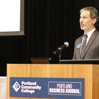 Marc Goldberg speaks at podium.