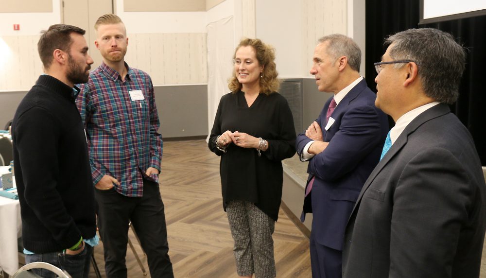 NW Compounders staff chat with PCC and Portland Business Journal representatives.