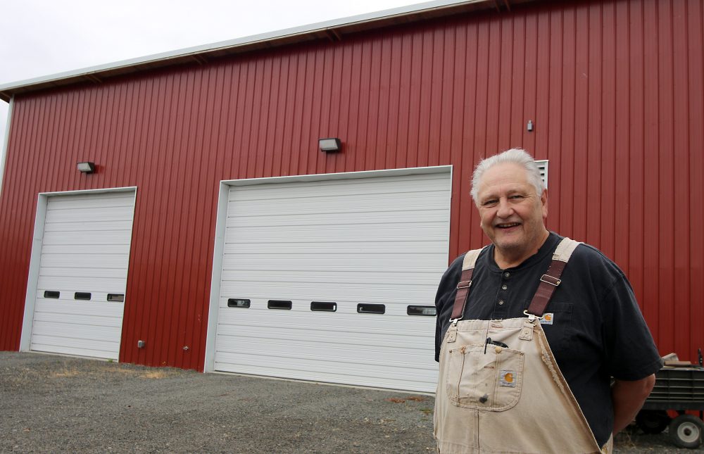 man standing in front of shop facility