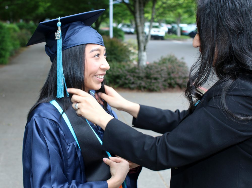 Margarita fixes Veyda's cap/